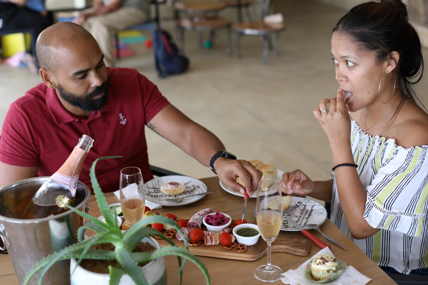 Guests sharing a tasting board with sparkling wine at Blue Crane Bistro.